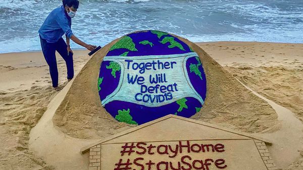 Puri: Sand artist Sudarsan Pattnaik creates a sand sculpture on the novel coronavirus with an awareness message 'Together We Will Defeat COVID-19', at Puri beach of Odisha, Tuesday, April 21, 2020. (PTI Photo) (PTI21-04-2020_000185B) (PTI) Puri: Sand artist Sudarsan Pattnaik creates a sand sculpture on the novel coronavirus with an awareness message 'Together We Will Defeat COVID-19', at Puri beach of Odisha, Tuesday, April 21, 2020. (PTI Photo) (PTI21-04-2020_000185B) (PTI)