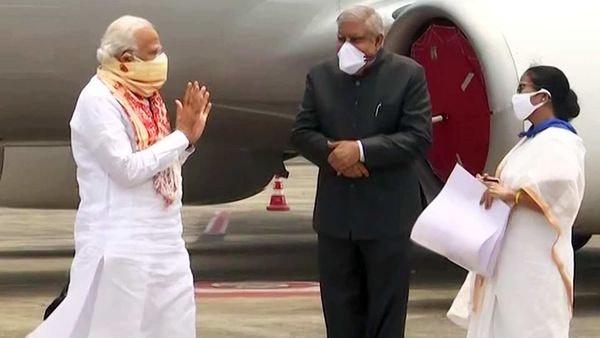 Prime Minister Narendra Modi received by West Bengal CM Mamata Banerjee and Governor Jagdeep Dhankhar on his arrival at Kolkata Airport on Friday. Prime Minister Modi will be conducting an aerial survey of the areas affected by Cyclone Amphan. (ANI Photo) Prime Minister Narendra Modi received by West Bengal CM Mamata Banerjee and Governor Jagdeep Dhankhar on his arrival at Kolkata Airport on Friday. Prime Minister Modi will be conducting an aerial survey of the areas affected by Cyclone Amphan. (ANI Photo)