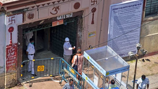 Devotees undergo thermal screening before they enter Kalighat temple as it reopened amid the COVID-19 lockdown, in Kolkata on Wednesday. (ANI Photo) Devotees undergo thermal screening before they enter Kalighat temple as it reopened amid the COVID-19 lockdown, in Kolkata on Wednesday. (ANI Photo)