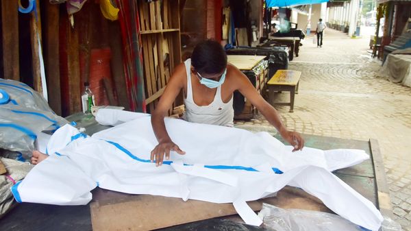 A man making PPE dress at his shop, in Kolkata on Saturday. (ANI Photo) A man making PPE dress at his shop, in Kolkata on Saturday. (ANI Photo)