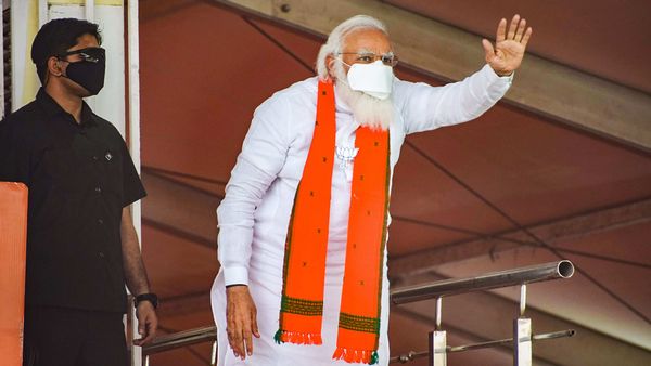 Bankura: Prime Minister Narendra Modi waves at the crowd during a public meeting ahead of the West Bengal Assembly Polls, in Bankura, Sunday, March 21, 2021. (PTI Photo)(PTI03_21_2021_000103B) (PTI) Bankura: Prime Minister Narendra Modi waves at the crowd during a public meeting ahead of the West Bengal Assembly Polls, in Bankura, Sunday, March 21, 2021. (PTI Photo)(PTI03_21_2021_000103B) (PTI)