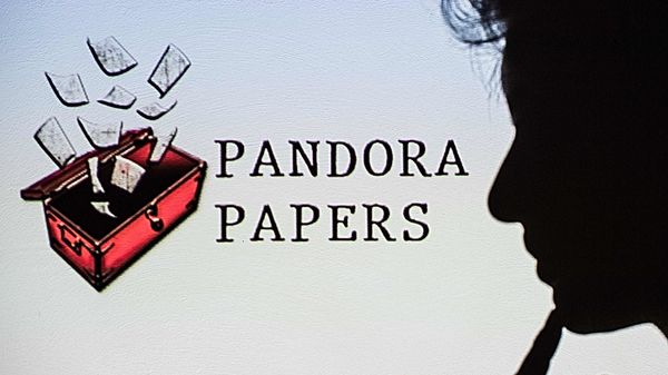This photograph illustration shows a woman's shadow cast on the logo of Pandora Papers, in Lavau-sur-Loire, western France, on October 4, 2021. - Russia on October 4 dismissed revelations leaked in the Pandora Papers as This photograph illustration shows a woman's shadow cast on the logo of Pandora Papers, in Lavau-sur-Loire, western France, on October 4, 2021. - Russia on October 4 dismissed revelations leaked in the Pandora Papers as