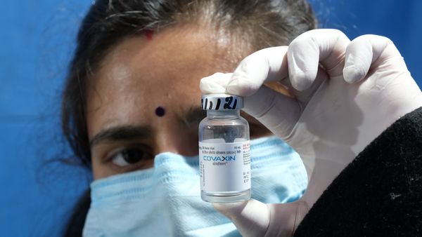 A health worker holds a bottle of Covaxin Covid-19 vaccine at a vaccination center set up at Maulana Azad Medical College in New Delhi, India, on Monday, Jan. 3, 2022. India may see a spurt in the Covid-19 growth rate within days and head into an intense but short-lived virus wave as the highly-infectious omicron variant moves through the crowded nation of almost 1.4 billion. Photographer: T. Narayan/Bloomberg (Bloomberg)