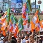 Bharatiya Janata Party (BJP) supporters climb over police barricades as they shout slogans and wave the party flag to condemn Rahul Gandhi, leader of the opposition party Indian National Congress (INC), during a protest over alleged derogatory remarks against BJP leader and India�s Prime Minister Narendra Modi, in Guwahati on August 31, 2025. (Photo by Biju BORO / AFP) (AFP)
