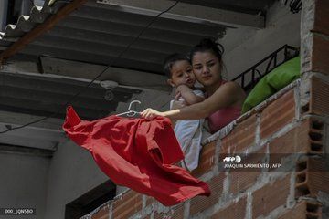 <p>Red rags act as distress signal to receive government aid amid Covid-19 crisis in Colombia's Medellin</p>