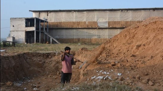 A worker preparing a burial site ahead of the culling of around 1.66 lakh poultry birds in Barwala belt. (Sant Arora/HT)