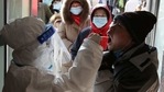 A medical worker in protective suit collects a swab from a resident during a mass nucleic acid testing following a recent coronavirus disease (COVID-19) outbreak in Shijiazhuang, Hebei province, China January 6, 2021. Picture taken January 6, 2021. China Daily via REUTERS(REUTERS)