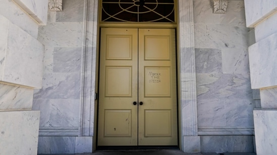 The phrase "Murder the media" is written on a door to the US Capitol on January 7. Democratic House Speaker Nancy Pelosi declared that “the president of the United States incited an armed insurrection against America.” She called him “a very dangerous person who should not continue in office," AP reported.(Erin Scott/REUTERS)