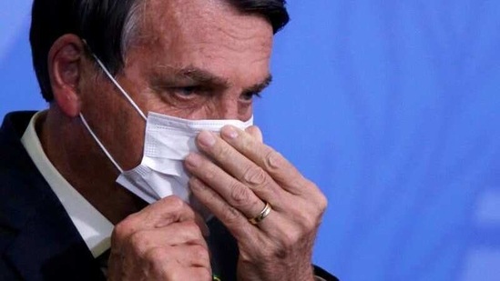 FILE PHOTO: Brazil President Jair Bolsonaro looks on as he adjusts his protective face mask during a ceremony launching a program to expand access to credit at the Planalto Palace in Brasilia, Brazil, August 19, 2020. REUTERS/Adriano Machado/File Photo(REUTERS)