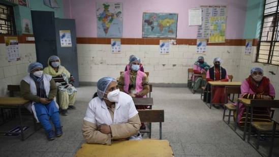 Volunteers wait to be registered during the dry run for Covid-19 vaccination at an MCD School in New Delhi on January 8. Union Health Minister Harsh Vardhan, who oversaw the dry run in Tamil Nadu said vaccines would be made available in the next few days and those at risk such as health care professionals would be given priority, PTI reported.(Vipin Kumar / HT Photo)