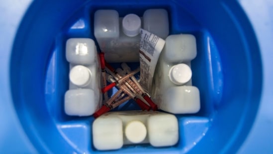Syringes and ice packs inside a vaccination box at Bandra Kurla Complex (BKC) in Mumbai on January 8. If vaccines packed in dry ice is being transported in the passenger cabin of an aircraft, then the flight crew should be properly trained on the hazards and risks of its transportation, the aviation regulator noted in the guidelines.(Pratik Chorge / HT Photo)