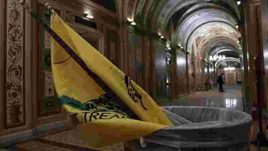 A flag is pictured in a trash can after supporters of US President Donald Trump were vacated from the US Capitol Building, in Washington on January 7.(Jonathan Ernst / REUTERS)