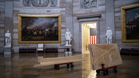 Hand trucks with stacks of plywood in the Rotunda of the US Capitol building on January 8. President Trump, in a video message on the night of the breach, condemned the storming, which occurred after he urged his angry supporters to take action, and said he would prepare for the administration of President-elect Joe Biden.(Al Drago/Bloomberg)