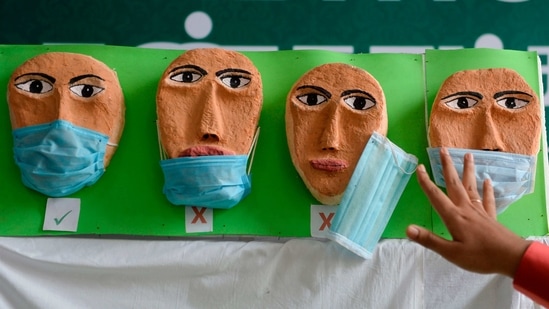 A health worker adjusts a mask on a Covid-19 awareness exhibit during the dry run at a government hospital in Chennai on January 8. The first nationwide mock drill was held on January 2 which, the health ministry said, helped to iron out any glitches in the final execution and further refinement of the operational procedures.(Arun Sankar / AFP)