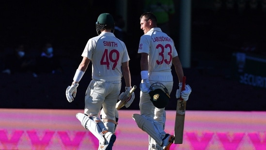 Australia's Steven Smith (L) and Marnus Labuschagne walk off the field at the end of the third day of the third cricket Test match between Australia and India at the Sydney Cricket Ground (SCG) in Sydney.(AFP)