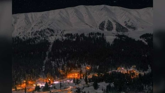 The twinkling lights of Gulmarg city reflecting on the snow capped mountains makes for a scene that words cannot do justice to. (Twitter/Caring_Raveed) The twinkling lights of Gulmarg city reflecting on the snow capped mountains makes for a scene that words cannot do justice to. (Twitter/Caring_Raveed)