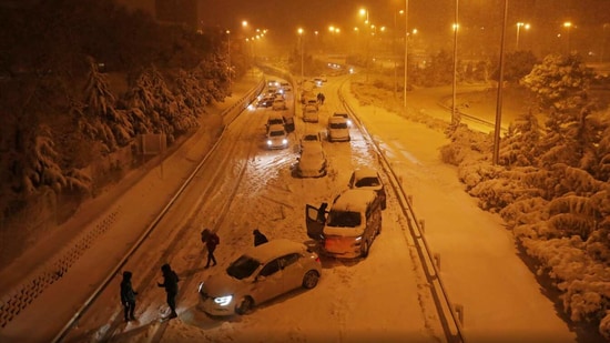 The M-30 and M-40 motorways near Madrid were among more than 400 roads where snow hindered vehicles. (Reuters)