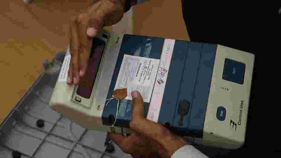 A polling official checks the control unit of an electronic voting machine at a dispatch center before proceeding to his allotted station.(AP) A polling official checks the control unit of an electronic voting machine at a dispatch center before proceeding to his allotted station.(AP)