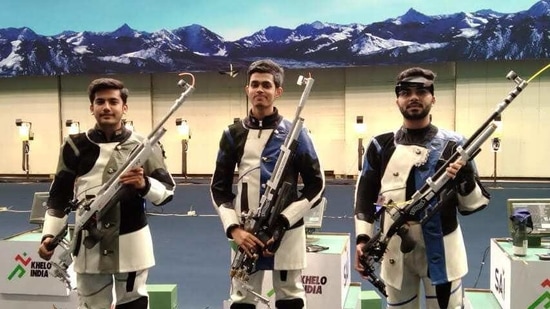Hriday Hazarika (centre) Aishwary Pratap Singh (left) and Arjun Babuta after the final of 10m air rifle event at Karni Singh range on Saturday. (HT Photo) Hriday Hazarika (centre) Aishwary Pratap Singh (left) and Arjun Babuta after the final of 10m air rifle event at Karni Singh range on Saturday. (HT Photo)