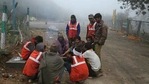 Indian laborers warm themselves around a fire on a cold morning.(AP) Indian laborers warm themselves around a fire on a cold morning.(AP)