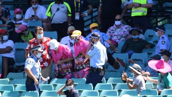 Police remove a group of spectators from their seats after Mohammed Siraj of India complained to umpires of being racially abused during day four of the third test match between Australia and India at the SCG, Sydney. (via REUTERS)
