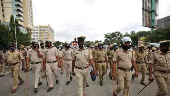 Indian police walk ahead of farmers protesting against new farming laws in Bangalore, India, Wednesday, Dec. 9, 2020. The farmers, fear new legislation will reduce their earnings and will result in exploitation by corporations, eventually rendering them landless. (AP Photo/Aijaz Rahi)(AP) Indian police walk ahead of farmers protesting against new farming laws in Bangalore, India, Wednesday, Dec. 9, 2020. The farmers, fear new legislation will reduce their earnings and will result in exploitation by corporations, eventually rendering them landless. (AP Photo/Aijaz Rahi)(AP)