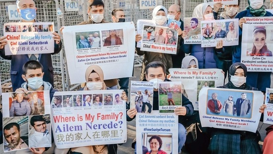 Members of the Muslim Uighur minority hold placards as they demonstrate in front of the Chinese consulate on December 30, 2020, in Istanbul.(AFP)