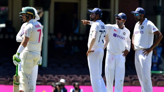 India's Mohammed Siraj (C) stands along with his teammates as Australia's captain Tim Paine (L) watches as the game was halted after allegedly some remarks were made by the spectators on the fourth day of the third cricket Test match between Australia and India at the Sydney Cricket Ground (SCG) in Sydney on January 10, 2021.(AFP)