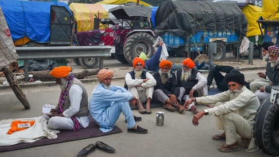 Farmers take rest during their ongoing protest against the new farm laws, at Singhu border in New Delhi, (PTI) Farmers take rest during their ongoing protest against the new farm laws, at Singhu border in New Delhi, (PTI)