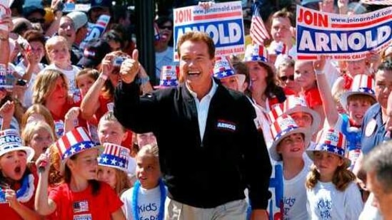 FILE - In this Oct. 5, 2003, file photo, Republican candidate for California governor Arnold Schwarzenegger walks up the steps to the state Capitol surrounded by children and waving to supporters during a campaign rally in Sacramento, Calif. California Gov. Gavin Newsom is facing a possible recall election as the nation's most populous state struggles to emerge from the coronavirus crisis. The prospect of the election is reviving memories of California's circus-like 2003 recall, in which voters installed Schwarzenegger as governor after deposing the unpopular Democrat Gray Davis. (AP Photo/Steve Yeater, File)(AP)