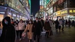 People wearing face masks walk on Jianghan street in Wuhan on January 10, 2021, the eve of the first anniversary of China confirming its first death from the Covid-19 coronavirus. (AFP) People wearing face masks walk on Jianghan street in Wuhan on January 10, 2021, the eve of the first anniversary of China confirming its first death from the Covid-19 coronavirus. (AFP)