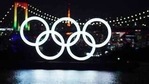 FILE - In this Dec. 1, 2020, file photo, a man and a woman walk past near the Olympic rings floating in the water in the Odaiba section in Tokyo. More than 80% of people in Japan who were surveyed in two polls in the last few days say the Tokyo Olympics should be canceled or postponed, or say they believe the Olympics will not take place. (AP Photo/Eugene Hoshiko, File)(AP) FILE - In this Dec. 1, 2020, file photo, a man and a woman walk past near the Olympic rings floating in the water in the Odaiba section in Tokyo. More than 80% of people in Japan who were surveyed in two polls in the last few days say the Tokyo Olympics should be canceled or postponed, or say they believe the Olympics will not take place. (AP Photo/Eugene Hoshiko, File)(AP)