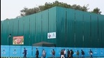 Pedestrians wearing walk past the construction site for the new Parliament building, part of the Central Vista redevelopment project, in New Delhi. (Bloomberg) Pedestrians wearing walk past the construction site for the new Parliament building, part of the Central Vista redevelopment project, in New Delhi. (Bloomberg)