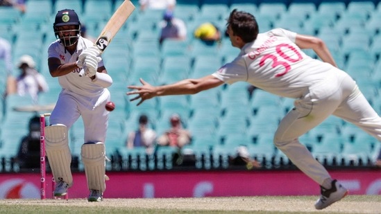 India's Cheteshwar Pujara hits the ball past Australia's Pat Cummins during play on the final day of the third cricket test between India and Australia at the Sydney Cricket Ground, Sydney, Australia, Monday, Jan. 11, 2021. (AP Photo/Rick Rycroft)(AP)