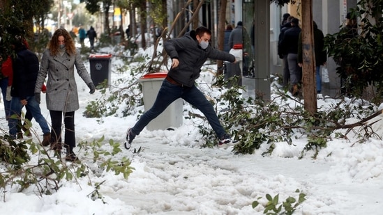 A man jumps over a snow-covered street in Madrid on January 10. The authorities are worried about the prospect of snow turning to ice, with temperatures expected to fall to up to minus 13 (9 Fahrenheit) on January 12.(Susana Vera / REUTERS)