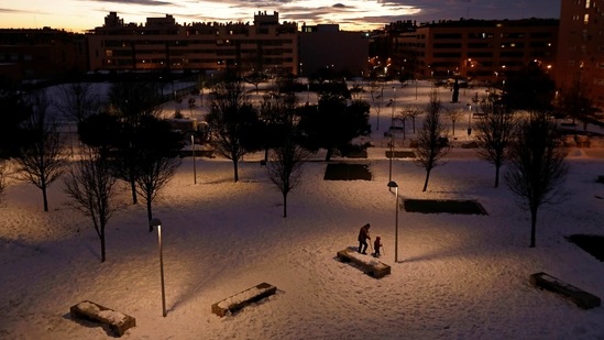 People using walking sticks to wade through the snow in Madrid on January 10. Most residents have heeded the government's call to stay at home, with the capital's streets all but deserted and quiet, except for the sound of shovels scraping snow and ice.(Susana Vera / HT Photo)