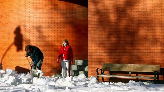 A worker shovels snow from the entrance of a building after heavy snowfall in Madrid on January 11. Throughout the weekend, people had been responding to calls to help clear vital paths in their neighbourhoods to allow access to hospitals and neighbourhood health centers.(Sergio Perez / REUTERS)
