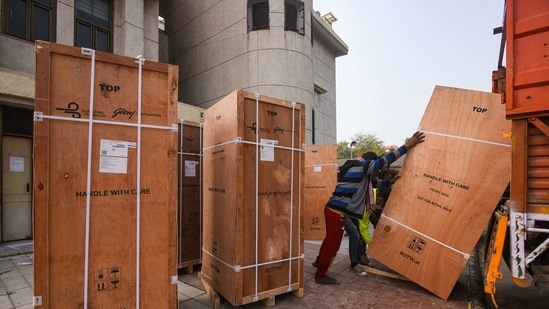 Refrigerators meant for Covid-19 vaccine storage being unloaded from a truck at Rajiv Gandhi Super Speciality Hospital in New Delhi on January 7. India plans to inoculate 300 million of its 1.3 billion people free of charge in the first six to eight months of this year. The Drug Controller General of India has approved two coronavirus vaccines for emergency use.(Amal KS / HT Photo)