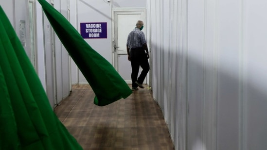 A health worker walks past a storage room during a trial run of Covid-19 vaccine delivery system in Mumbai, on January 8. India added 16,311 new cases of the coronavirus disease (Covid-19) and 161 related deaths in the previous 24 hour period as the country moves towards rolling out vaccinations.(Rajanish Kakade / AP)