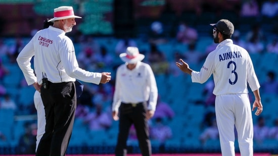 Indian captain Ajinkya Rahane, right, gestures as he speaks with umpire Paul Wilson during play on day three of the third cricket test between India and Australia at the Sydney Cricket Ground, Sydney, Australia, Saturday, Jan. 9, 2021. (AP Photo/Rick Rycroft)(AP)