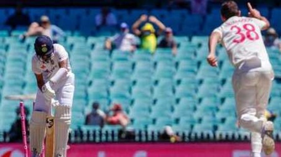 India's Cheteshwar Pujara, left, is out bowled by Australia's Josh Hazlewood, right, during play on the final day of the third cricket test between India and Australia at the Sydney Cricket Ground, Sydney, Australia, Monday, Jan. 11, 2021. (AP Photo/Rick Rycroft)(AP)