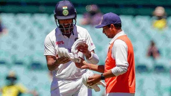India's Cheteshwar Pujara selects a new pair of gloves during play on the final day of the third cricket test between India and Australia at the Sydney Cricket Ground, Sydney, Australia, Monday, Jan. 11, 2021. (AP Photo/Rick Rycroft)(AP)