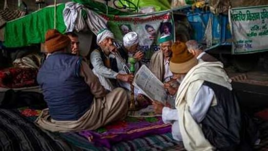 A group of farmers share a hookah as they chat while blocking a major highway in protest against new farm laws at the Delhi-Uttar Pradesh state border, India, Monday, Jan. 11, 2021. (AP Photo/Altaf Qadri) (AP) A group of farmers share a hookah as they chat while blocking a major highway in protest against new farm laws at the Delhi-Uttar Pradesh state border, India, Monday, Jan. 11, 2021. (AP Photo/Altaf Qadri) (AP)