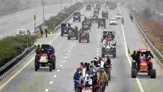 Farmers atop tractors during a rally in protest against new farm laws, in Dasna on January 7. Thousands of farmers protesting on Delhi’s borders demanding repeal of three contentious farm laws carried out a tractor march on January 7, converging on the eastern and western peripheral expressways that form a ring around Delhi. (Sakib Ali / HT Photo)