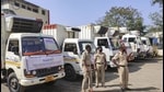 Police personnel guard the trucks to be used to transport the Covishield vaccine from Serum Institute of India to different parts of the country, in Pune on January 11. (PTI) Police personnel guard the trucks to be used to transport the Covishield vaccine from Serum Institute of India to different parts of the country, in Pune on January 11. (PTI)