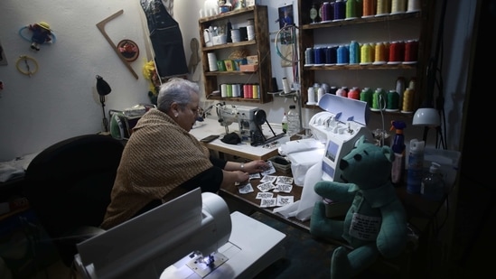 Erendira Guerrero makes stuffed bears for people who lost a family member to Covid-19, using one of the deceased's articles of clothing in Ciudad Juarez, Mexico on January 11. In her small home workshop in this Mexican border city, Guerrero makes these teddy bears so that relatives who have lost a loved one to Covid-19 have something to hold onto. (Christian Chavez / AP) Erendira Guerrero makes stuffed bears for people who lost a family member to Covid-19, using one of the deceased's articles of clothing in Ciudad Juarez, Mexico on January 11. In her small home workshop in this Mexican border city, Guerrero makes these teddy bears so that relatives who have lost a loved one to Covid-19 have something to hold onto. (Christian Chavez / AP)