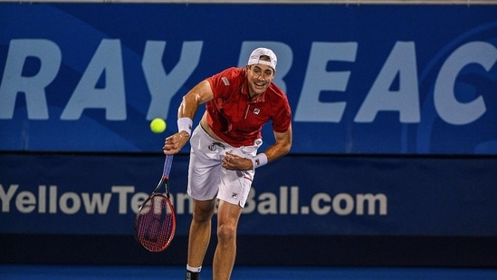 DELRAY BEACH, FLORIDA - JANUARY 11: John Isner of the United States serves against Sebastian Korda of the United States.(AFP)