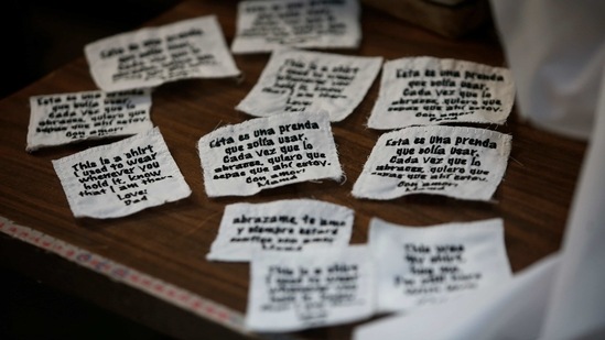 Tags ready to be sewn onto bears made for people who lost a loved one to Covid-19, out of one of the deceased's articles of clothing, sit beside a sewing machine in Erendira Guerrero’s home workshop on January 11. She estimates she has made about 200 bears for the families of Covid-19 victims. (Christian Chavez / AP) Tags ready to be sewn onto bears made for people who lost a loved one to Covid-19, out of one of the deceased's articles of clothing, sit beside a sewing machine in Erendira Guerrero’s home workshop on January 11. She estimates she has made about 200 bears for the families of Covid-19 victims. (Christian Chavez / AP)