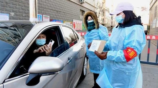 At a highway checkpoint, police in protective gowns ordered a car entering Beijing to return to Hebei after the driver was unable to show proof of a negative coronavirus test. (REUTERS)