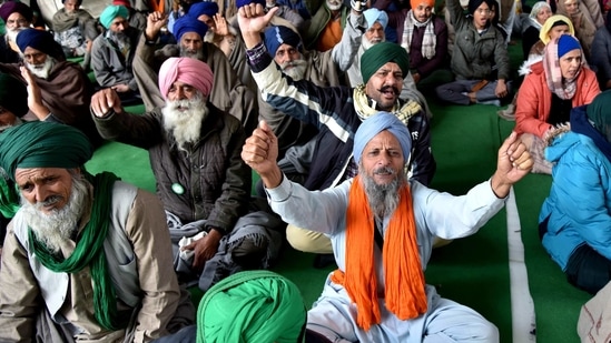 Farmers shout slogans during an ongoing protest against the new farm laws, at the Singhu border in New Delhi on Tuesday.(ANI Photo )